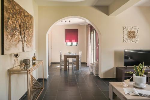 a living room with a table and a dining room at Queen Bee Residence in Minia