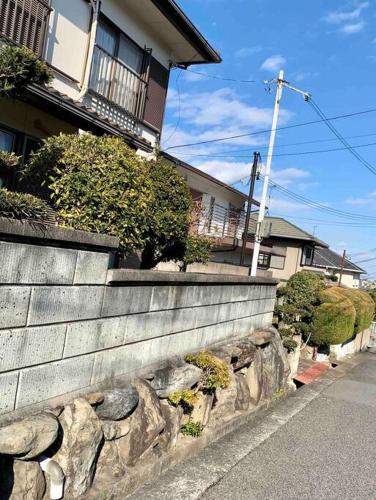 a stone wall in front of a house at Amitie Villa in Hannan