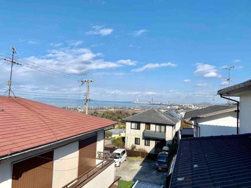 a view of a city from the roofs of houses at Amitie Villa in Hannan