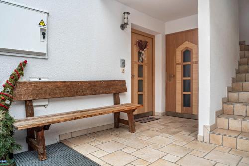 a wooden bench sitting on the side of a building at Huterhof Apt Talblick in Riobianco