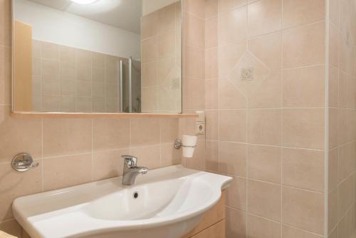 a bathroom with a sink and a mirror at Huterhof Apt Talblick in Riobianco