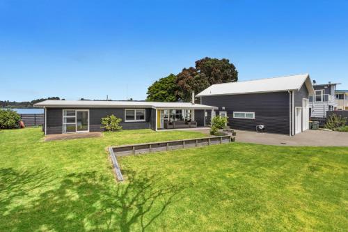 a house with a large yard in front of it at Harbourside - Ohope Holiday Home in Ohope Beach