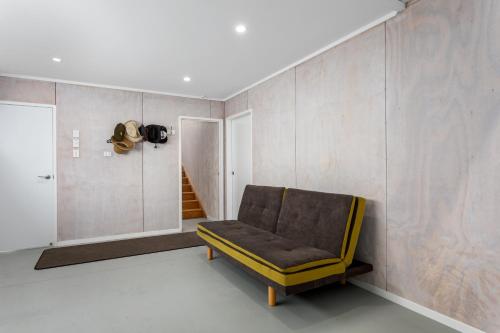 a living room with a couch in a room at Harbourside - Ohope Holiday Home in Ohope Beach
