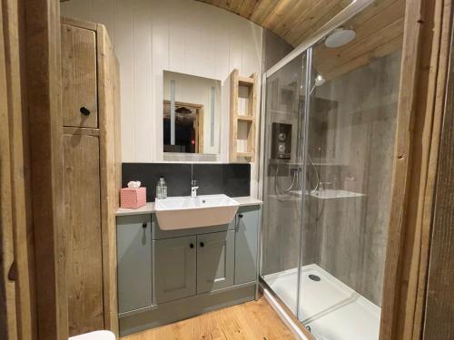 a bathroom with a sink and a shower at The Huddle at Big Sky Brisley in Brisley