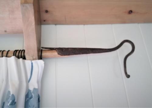 a knife hanging on the wall of a bathroom at The Huddle at Big Sky Brisley in Brisley