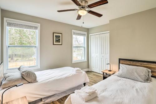 a bedroom with two beds and a ceiling fan at Contemporary Home 8 Mi to Downtown Asheville! in Asheville