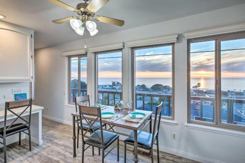 a dining room with a table and chairs and windows at Pet-Friendly Cayucos Home with Ocean Views! in Cayucos