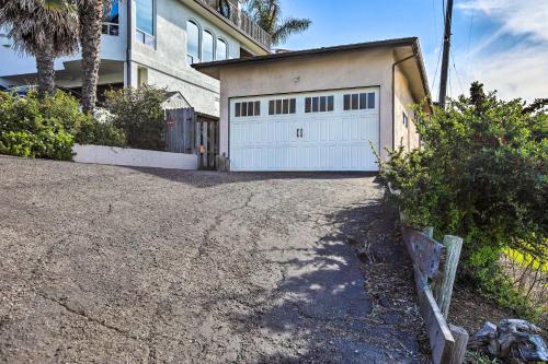 a house with a white garage and a driveway at Pet-Friendly Cayucos Home with Ocean Views! in Cayucos