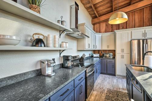 a kitchen with white cabinets and blue counter tops at Fort White Retreat Deck and River Access! in Fort White