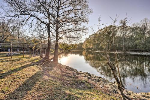 a body of water with trees next to it at Fort White Retreat Deck and River Access! in Fort White