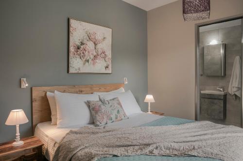a bedroom with a large bed with white pillows at Queen Bee Residence in Minia