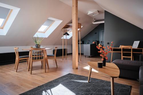 a living room with a table and chairs at Vanadziņa māja in Cēsis