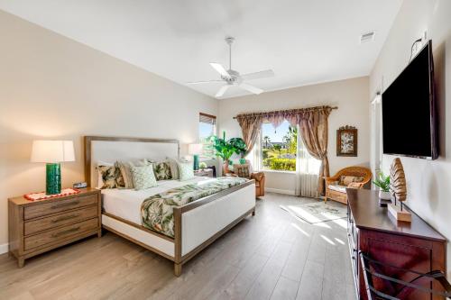 a bedroom with a bed and a flat screen tv at Camino Casa in Indio