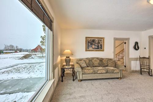 a living room with a couch and a large window at Charming Stevensville Home with Open Yard! in Stevensville