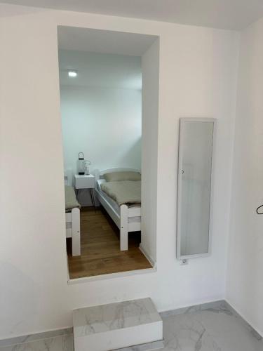 a mirror in a white room with a bed at Lena 2 in Jajce