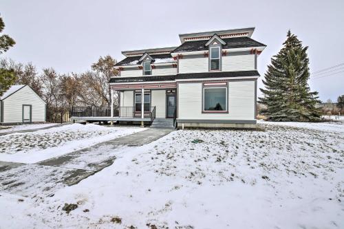 a white house with snow on the ground at Charming Stevensville Home with Open Yard! in Stevensville