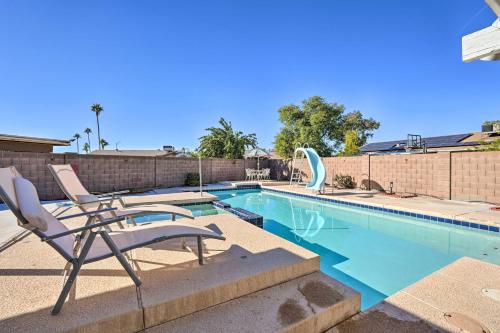 a swimming pool with a chair and a slide at Families with Pets Welcome! Poolside Gem in Phoenix in Phoenix