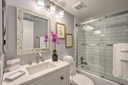 a bathroom with a sink and a toilet and a mirror at Families with Pets Welcome! Poolside Gem in Phoenix in Phoenix