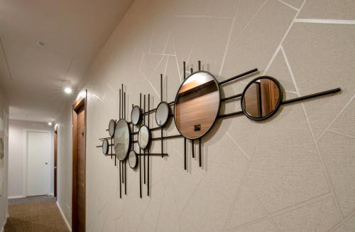 a mirror hanging on a wall in a hallway at AH - Duomo Essence in Milan