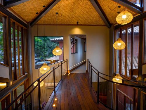 a hallway of a house with windows and lights at Buzios Espiritualidade Hotel in Búzios