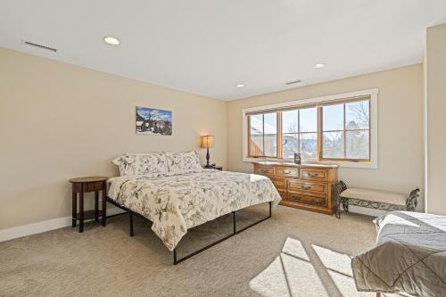 a bedroom with a bed and a window at Durango Deluxe Townhome in Durango