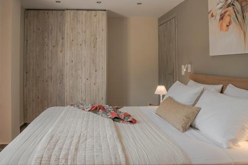 a bedroom with a large white bed with flowers on it at Queen Bee Residence in Minia