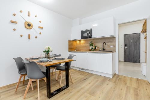 a kitchen and dining room with a table and chairs at KORZO LIPNO 2 in Lipno nad Vltavou