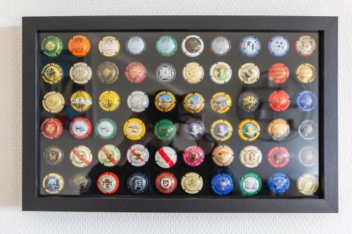 a display case filled with lots of different colored watches at Superbe studio 'Chardonnay' avec vue sur la vallée in Hautvillers