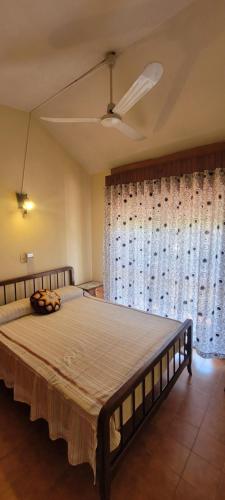 a large bed in a bedroom with a large window at HERMINIA in Villa Carlos Paz