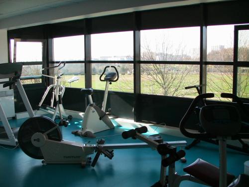 a room with a gym with two exercise bikes at Sphinx Résidences - Tempologis Mémorial in Caen