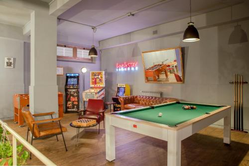a billiard room with a pool table and chairs at Bloom Hotel Rome in Rome