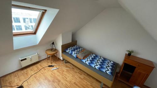 Habitación pequeña con cama en el ático en Großzügige Maisonette Wohnung über den Dächern Leipzigs, en Leipzig