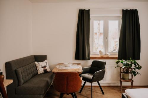 a living room with a couch and a table at Wohnung Hochalm in Lenggries