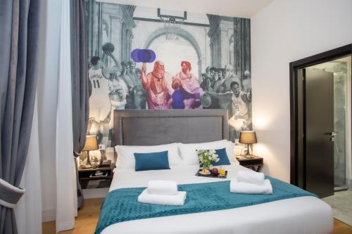 a bedroom with a large bed with a painting on the wall at Casual Rinascimento Firenze in Florence