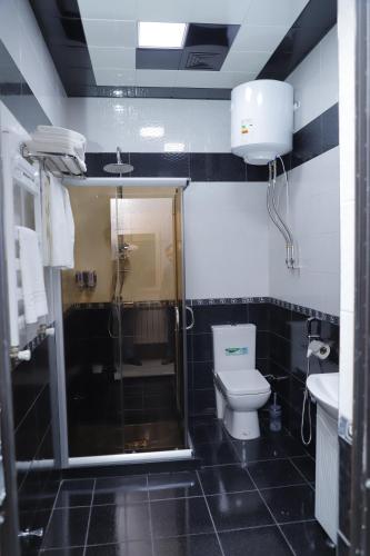 a bathroom with a shower and a toilet and a sink at RamRamay in Qax