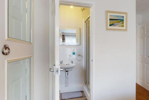 a bathroom with a sink and a mirror at Alberts Retreat in Abergele