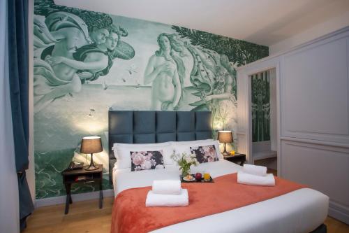 a bedroom with a large bed with a painting on the wall at Casual Rinascimento Firenze in Florence