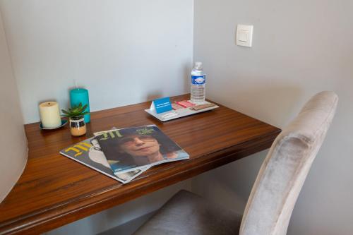 a wooden table with a magazine on top of it at Zenitude Hôtel-Résidences Le Cannet in Le Cannet