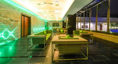 a lobby with tables and chairs and a swimming pool at The Light Hotel Penang in Perai