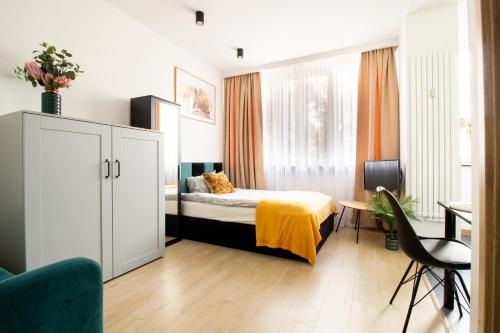 a bedroom with a bed and a desk and a chair at PiotrApartments Luxury Apartments in City Centre in Warsaw