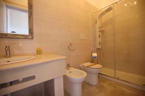 a bathroom with a sink and a toilet and a shower at B&B Royal in Sellia Marina
