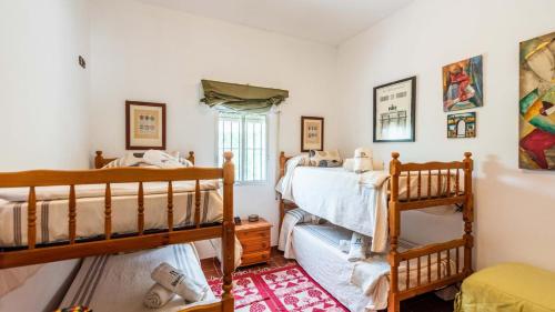 A bed or beds in a room at Casa Campo La Capilla Los Palacios y Villafranca by Ruralidays