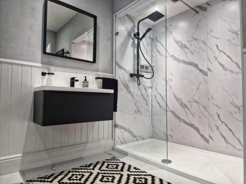 a bathroom with a sink and a shower at Bounty Town House Cumbria in Whitehaven