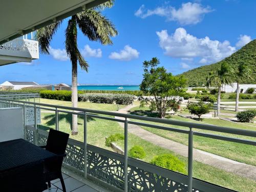 a balcony with a view of the ocean at Le Domaine Anse Marcel Beach Resort in Anse Marcel 