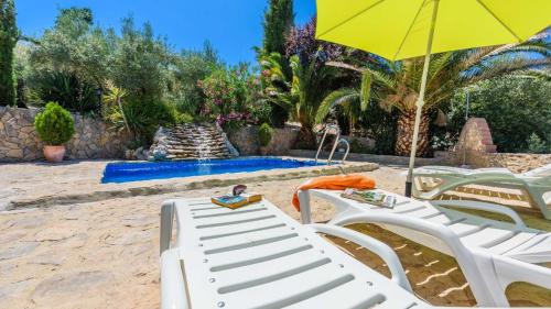 a group of chairs and an umbrella and a pool at Combinación Cortijo y Mirador Casablanca Priego de Córdoba by Ruralidays in Priego de Córdoba