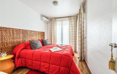 a red bed in a room with a window at Amazing Home In Aznalcázar With Wifi in Aznalcázar