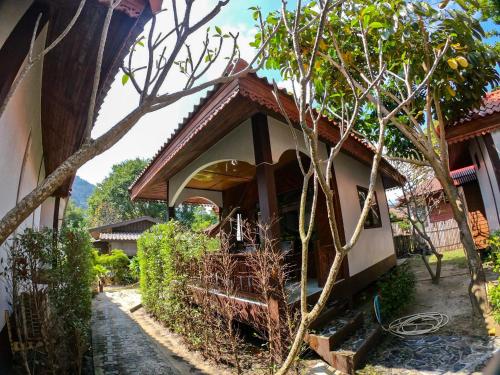 a house with a tree in front of it at Pen's Bungalow Koh Phangan in Thong Nai Pan Yai