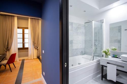 a bathroom with a tub and a sink at Casual Rinascimento Firenze in Florence