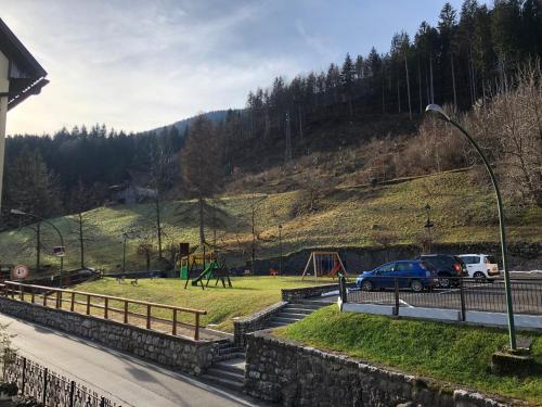 a parking lot with a park with a playground at Mountain House in Rigolato