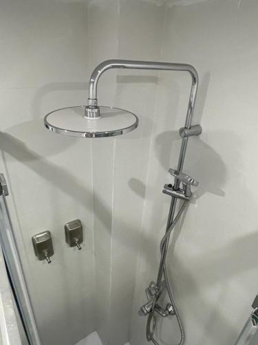 a glass shower stall with a shower head in a bathroom at Self check-in! Apartment in the heart of Málaga! in Málaga